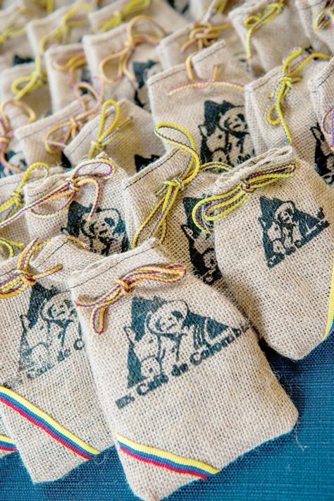 Each wedding guest received a small bag of Colombian coffee beans—an homage to the groom's family. A waterfront home in Leesburg is the idyllic backdrop for this stylish backyard wedding. Lakeside Soire - Orlando Magazine - June 2016 - Orlando, FL Colombian Inspired Wedding, Colombian Theme Party Decorations, Colombian Birthday Party, Colombia Party Decorations, Colombian Wedding Ideas, Colombian Wedding Favors, Colombia Party, Colombian Wedding Traditions, Costa Rica Wedding Favors