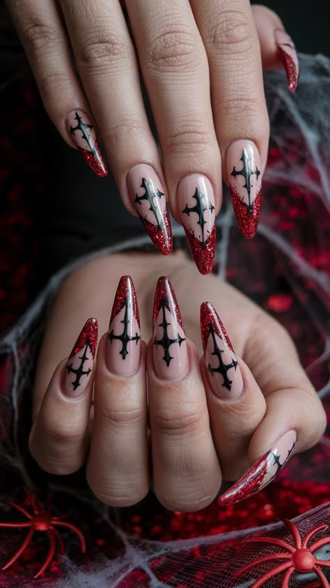 Make a bold statement this Halloween with these stunning acrylic nails! Featuring a sleek beige base adorned with vibrant red glitter and intricate cross wing designs, these nails blend elegance with a hint of edginess. Perfect for the stylishly spooky! #halloweennails #halloweenvibe #nailsdesign #acrylicnails #nailsinspo #octobernails Spiderweb Nails Coffin, Goth Medium Nails, Simple Goth Nails Coffin, Gothic Christmas Nails Simple, Vampy Nail Art, Christmas Nail Ideas Stiletto, Dark Valentine’s Day Nails, Ghost The Band Nails, Spooky Holiday Nails