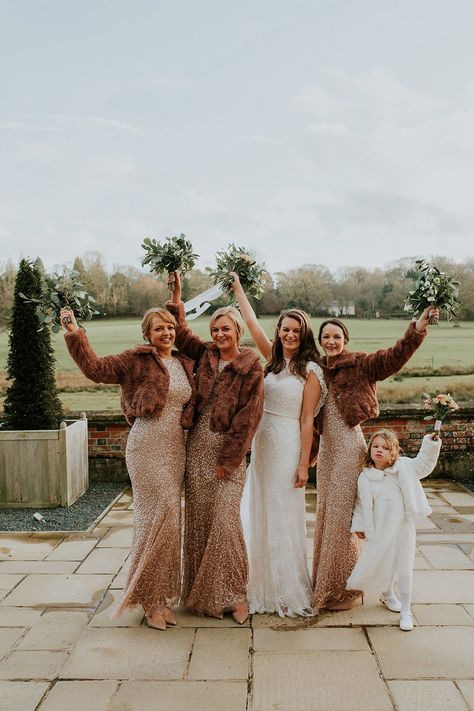 Bridesmaids in fitted gold sparkly bridesmaid dresses with faux fur coverups | See more of this <a href="https://www.rockmywedding.co.uk/burley-manor" target="_blank" rel="noopener">real wedding</a> | Hayley Savage Photography Winter Wedding Cover Up Bridesmaid, Cold Weather Bridesmaid Outfit, Rehersal Dinner Dress Bridesmaid Winter, Bridesmaid Dresses Champagne Rose, Bridesmaid Dresses Fairy, Bridesmaid Dresses Christmas, Sparkly Wedding Decor, Bridesmaid Bouquet Pink, Bridesmaid Dresses Winter Wedding