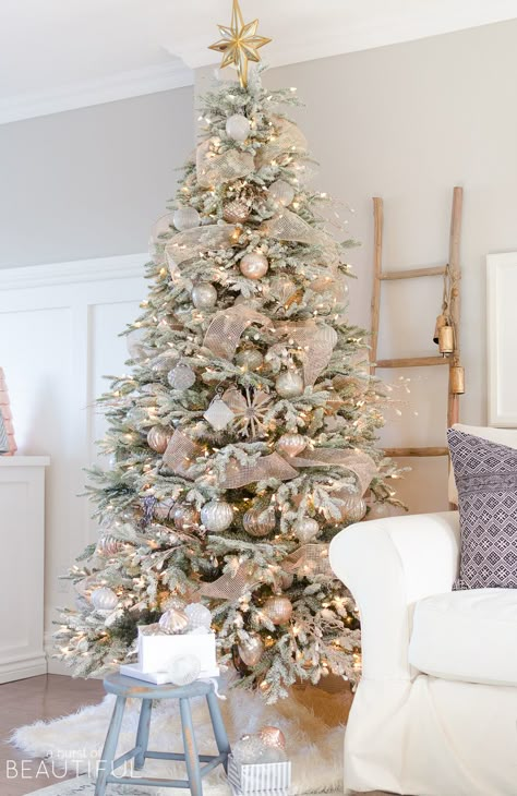 A snowy flocked Christmas tree decorated in silver and rose gold adds a big dose of holiday cheer to this modern farmhouse living room Rose Gold Christmas Decorations, Flocked Christmas Tree, Snowy Christmas Tree, Flocked Christmas Trees Decorated, Rose Gold Christmas, Farmhouse Christmas Tree, A White Christmas, Gold Christmas Decorations, Christmas Tree Inspiration