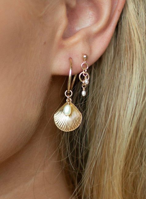 ALANA MARIA JEWELLERY - This enchanting piece will become a favourite in your collection. Captivating upon first glance these earrings feature a charming shell pendant accompanied by a Freshwater Pearl details and delicately hung from a 14k gold-filled Hoop. Adorn yourself with the beautiful Ula Shell Hoop earrings, pair alone or in a stack to achieve a beautifully curated ear. - Sold as a pair- Hoop earring- Shell pendant feature-Freshwater Pearl detail- 14k gold-filled Hoop measurement: 15mm Please note, due to hygienic purposes we do not refund or exchange any Alana Maria Jewellery earrings Alana Maria Earrings, Infinite Jewelry, Alana Maria, Gold And Pearl Earrings, Shell Hoop Earrings, Shell Accessories, Curated Ear, Surf Jewelry, Christian Bracelets