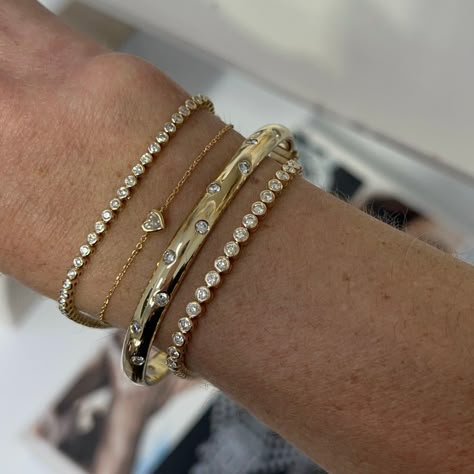 This sleek bangle captivates with scattering flush set diamonds set in 14k gold. Carefully crafted with comfort in mind, this bangle is easy to wear every day and a perfect addition to your stack if you're wanting to add more gold with a touch of sparkle! Available in 14k Yellow Gold, White Gold or Rose Gold Total Carat Weight: 1.75 cts Color: G/H Clarity: VS2 Closure: Hinge Made to order. Lead time is 4 weeks. Benefits of Solid 14k Gold Jewelry Most loved for its durability and longevity Can be Gold Bracket Stack, Gold And Diamond Bracelet, Flush Set Diamond, Stacked Bangles, Classy Jewelry, Gold Diamond Jewelry, Stacked Jewelry, Jewelry Lookbook, Gold Bangle