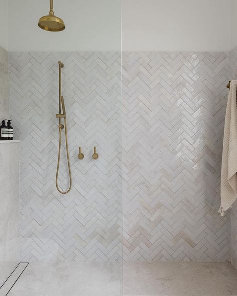 Bathroom Inspiration via @ambathrooms featuring our hand made Bejmat tiles laid in herringbone pattern 🤍 #bathroomstyle #luxurybathrooms #bathroomsofinstagram #herringbone #handmadetiles #bathroomstyling #tiles #shower #dilorenzotiles Pattern Tiled Bathroom, Porcelain Herringbone Tile, Herringbone Floors Bathroom, Marble Herringbone Shower Tile, Feature Bathroom Tiles, Tile Ideas For Bathroom Floor, Bathrooms With Gold Accents, Cream Herringbone Tile Bathroom, Fishbone Tiles Bathroom