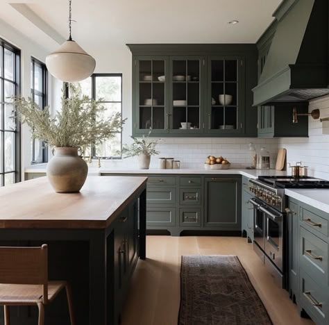 Green Cream Kitchen, Earthy Green Kitchen Cabinets, Kitchens With Black Islands, Green Black And White Kitchen, Kitchen With Black Windows, Earthy Tone Kitchen, Earthy Green Kitchen, Two Tone Kitchen Cabinets Green, Luxury Farmhouse Interior