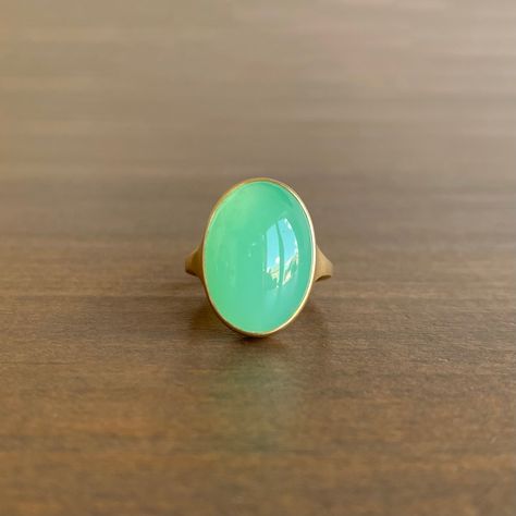 An enchanting combination of glowing green chrysoprase and sumptuous yellow gold. 18k yellow gold Chrysoprase, 10.85 carats, 12mm x 17mm (1/2" x 11/16") Yellow Gold Emerald Chrysoprase Cabochon Ring, Green Oval Chalcedony Rings, Oval Green Chalcedony Rings, Gold Oval Chrysoprase Emerald Ring, Yellow Gold Chrysoprase Cabochon Ring, Modern Rings, Chrysoprase Jewelry, Chrysoprase Ring, Chalcedony Ring