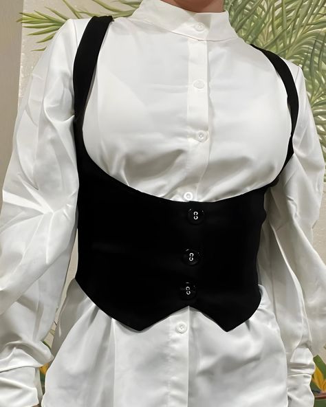 This stunning Gothic vest is perfect for the modern woman. Crafted with quality materials, this crop top features a sleek design with a button-up closure. Versatile and chic, ideal for casual wear, streetwear, or adding elegance to any outfit. Available in sizes S, M, and L, ensuring a comfortable and flattering fit for every body type. Embrace your inner fairy with this enchanting vest, blending fairycore and cottagecore seamlessly. Incorporating historical fashion, exuding a Renaissance charm White Button Up With Black Corset, Edgy Tank Top Outfit, Layered Corset Top Outfit, Corset Vest Women, Button Up With Corset Outfit, Corset Office Outfit, Underbust Vest, Outfits With Corsets Tops, Steampunk Vest Women