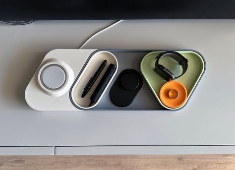 Declutter your desk or have a single place to store all of your daily essentials with this modern, modular & colourful catchall tray and desk organiser with an optional MagSafe charger add-on.  🎨 Printed from recycled PLA plastic you can choose from the following colour accents:  - Sunrise Orange/Mint - Sapphire Blue/Ice - Rose/Sakura Pink - Black/Black WHAT'S INCLUDED? ℹ️ If you purchase only the tray you'll get:  - 1x main tray in gray - 1x triangular tray in the accent colour of your choice - 1x oval tray in white  - 1x circular tray in the accent colour of your choice ℹ️ If you purchase the tray & the MagSafe add-on you'll get: - 1x main tray in gray - 1x triangular tray in the accent colour of your choice - 1x oval tray in white  - 1x circular tray in the accent colour of your choice Modular Desk Organizer, Modern Desk Decor, Unique Desk Organizer, Modern Product Design, Desk Interior, Accessory Organizer, Modular Desk, Organizer Desk, Drukarka 3d