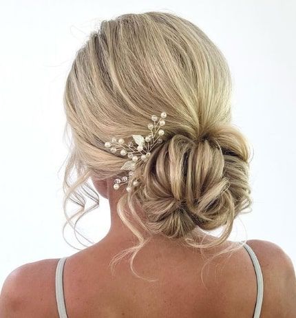 Ousled Low Updo Bun Inspiration Maid Of Honor Hairstyles Low Buns, Low Bun Updo Bridesmaid, Bridesmaid Hair Updo With Flowers, Bridesmaid Hair Low Updo, Low Messy Bun Wedding Hair With Veil, Bride Hairstyles Updo Bun Loose Curls, Low Messy Bridal Bun, Middle Bun Wedding Hair, Loose Low Bun Hairstyles