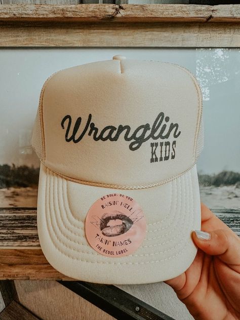 Stylish and fun, the "Wranglin' Kids Hat" adds boho western flair to any outfit. Perfect for adventurous families. Shop The Bevel Label now! All Hat No Cattle, Womens Hunting Hat, Western Outfit Accessories, Western Themed Gifts, Outfit With Trucker Hat, Brand Merch Ideas Products, Baseball Mom Trucker Hat, Women Trucker Hat, Mama Trucker Hat