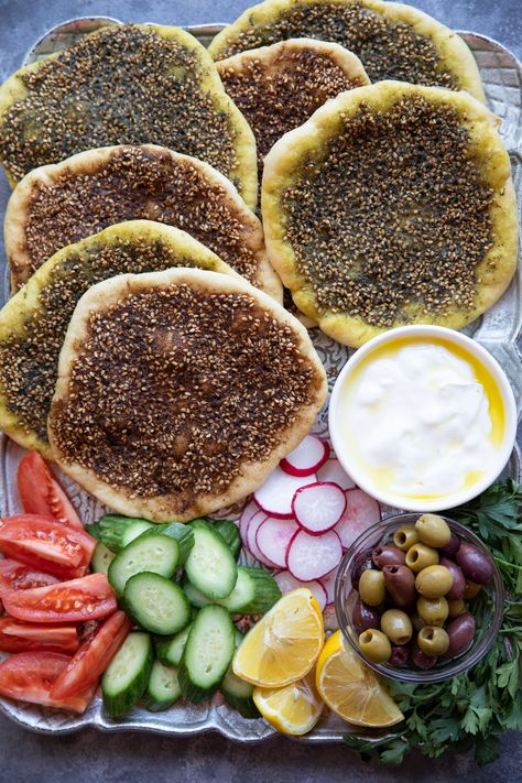 Manakish zaatar is a classic Middle Eastern flatbread topped with olive oil and zaatar spice. Zaatar is a combination of spices and has a wonderful earthy flavor. This bread is so easy to make and is perfect for breakfast with some cheese! Learn how to make this simple Middle Eastern vegan bread with just a few ingredients, you're going to love it! Middle Eastern Sandwiches, Middle Eastern Pizza, Breakfast Middle Eastern, Dinner Party Middle Eastern, Middle Eastern Food Board, Middle Eastern Feast, Middle Eastern Brunch Ideas, Middle Eastern Breakfast Ideas, Middle Eastern Food Aethstetic