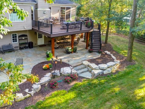 Patio Under Deck With Fire Pit, Backyard With Deck And Patio, Patio Below Deck Ideas, Under Deck Porch Ideas, Space Under Deck Ideas, Patio On A Sloped Yard, Under Deck Garden Ideas, Landscaping On A Slope Backyard, Patio Under Deck Walkout Basement