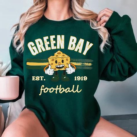 Womens Green Bay Football Sweatshirt, Green Bay Football Fan Shirt, Green Bay Game Day Shirt,Green Bay Fan Gift, Greenbay Crewneck SHIPS IN 1-2 BUSINESS DAYS.. PLEASE IGNORE ETSY'S SHIPPING TIMES, IT IS NOT ACCURATE    .: Made with a medium-heavy fabric blend of 50% cotton and 50% polyester (8.0 oz/yd² (271.25 g/m this sweatshirt feels cozy and is the perfect choice for those colder months. .: The classic fit along with the crew neckline deliver a comfy wearing experience with a clean-cut style. Meanwhile, the double-needle stitching at the shoulder, armhole, neck, waistband, and cuff seams add top-tier durability.  .: Say goodbye to itchiness thanks to the gray, pearlized tear-away label.  .: Made using 100% ethically grown US cotton. Gildan is also a proud member of the US Cotton Trust P Green Bay Packers Sweatshirt, Football Fan Shirts, Green Bay Packers Shirts, Cute Shirt Designs, Football Sweatshirt, Game Day Shirts, Fan Shirts, Green Bay Packers, Football Fans