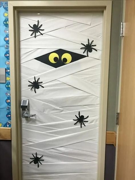 25+ DIY Halloween Classroom Door Decorations - HubPages Halloween Door Office Decorations, Front Office Halloween Decor, School Door Halloween, Seasonal Classroom Door Ideas, Halloween Themes For Office, Door Decorating Ideas For Halloween, Mummy Classroom Door, Halloween Library Door Decorations, Trick Or Treat Door Decorations