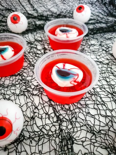 Eerie! Spooky! Wacky! These are just some of the expressions your guests should have this coming Halloween. Nothing on the menu will achieve that expression as compared to these Eyeball Jello Shots. These deliciously boozy treats are perfect for a spooky Halloween party.Making these Eyeball Jello Shots is surprisingly easy and straightforward. However, note that the recipe includes alcohol and is not fit for kids. By now, you probably have a lot of questions concerning the Eyeball Je… Hello Shots Halloween, Halloween Jello Ideas, Eyeball Jello, Halloween Jello Shots, Halloween Jello, Pelottava Halloween, Boozy Treats, Postres Halloween, Halloween Punch