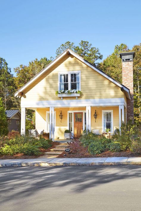 Serenbe, Georgia | Homeowners who aren't afraid of splashes of bright hues. You’ve probably already noticed how color can completely change and revamp a city. Just take a look at the Rainbow Row district in Charleston, South Carolina. The tourist attraction and postcard fixture draws crowds from all over to take in the beautifully-hued series of private Antebellum-style homes lining the street. It’s obvious designers of the Victorian era embraced color palettes. House With White Trim, Yellow House Exterior, Yellow Cottage, Cottage Exterior, Casas Coloniales, Yellow House, Yellow Houses, Casa Exterior, House Color