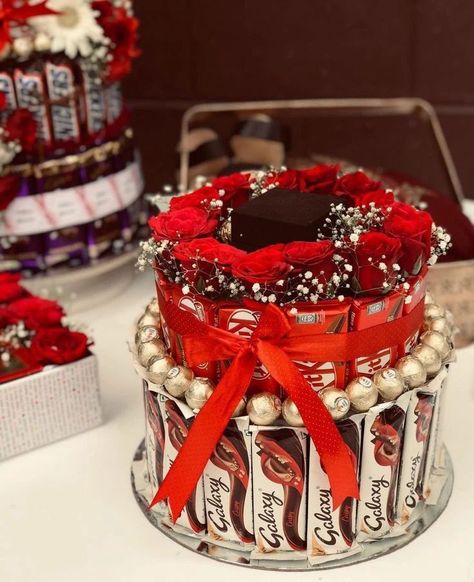 Chocolate Tower..... ❣️ Dm for orders @crafting_with_zana #Chocolatetower#chocolatehamper#crafts#engagement#wedding#love#giftideas#chocolate#hampers#flowerdecor#happiness#diy#diyideas#engajamentoinsta#weddinggifts#instapicframes#share#like#follow#affordable#price#moments Engagement Kavidi Ideas, Chocolate Hamper Ideas Gifts, Engagement Arrangements, Shagun Thali, Chocolate Tower, Wedding Hampers, Candy Bar Bouquet, Diy Hair Accessories Tutorial, Gubahan Hantaran