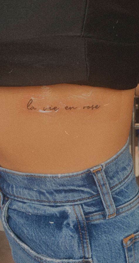 la vie en rose, himym, how i met your mother, tattoo, small, small tattoo, ti t, tiny tattoo, rib tattoo, side boob tattoo, french, life in pinm, france, ink, tattooinspo, inspo, small tattoo inspo La Vie En Rose Spine Tattoo, Small Tattoos Women Arm, La Vie En Rose Tattoo Fonts, Tattoo Ideas French, Cute French Tattoos, France Inspired Tattoo, Small Tattoos Ribcage, French Tattoos For Women, Tiny Rib Tattoos For Women