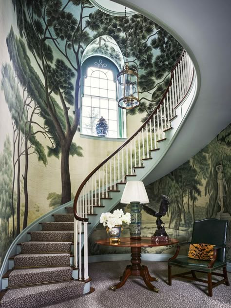 Designer Miles Redd: A mural of an Italian landscape forms a grand Arcadian canopy over the domed clockwise stairwell, wrapping it in towering greenery. Custom-printed mural, Iksel Decorative Arts. Veranda Magazine. 1920s Georgian-style house, Greenwich, CT woodland fantasia. The idyllic panorama spans the walls of the entrance hall and envelops the serpentine main staircase, the verdant canopy soaring up to the second-floor landing. Decoration Cage Escalier, Greenwich House, Veranda Magazine, Georgian Style Homes, 1920s House, Scenic Wallpaper, The Staircase, Painted Walls, Painted Wall