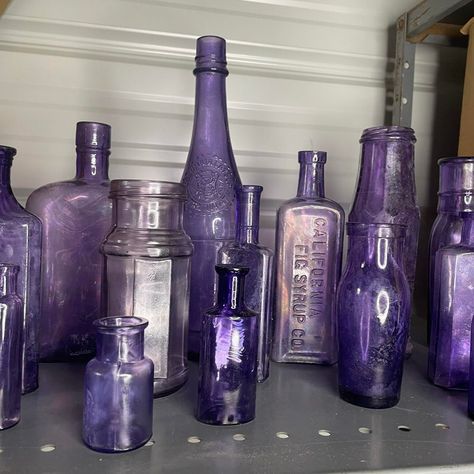 A set of 16 antique purple bottles and jars of varying sizes. Most pieces are free from chips and cracks, but most have a white haze to the bottle. I have been somewhat successful with using petroleum jelly in removing some of the haziness. California Fig Syrup bottle, Columbia Catsup bottle are a couple of the ones being offered in this healthy-sized collection.  A little background info on these purple bottles. Some, possibly all of these bottles were not originally purple / Amethyst. The colo Fig Syrup, Purple Bottle, Purple Gothic, Syrup Bottle, Purple Bedrooms, Antique Glass Bottles, Rustic Traditional, Purple Decor, Petroleum Jelly