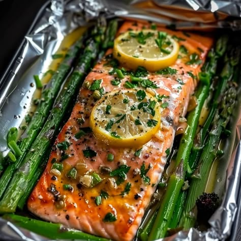 Baked Salmon in Foil with Asparagus and Garlic Lemon Butter Sauce - Simply Recipes - Fewer Worries, More Delight Asparagus And Salmon Bake, Salmon Recipes With Asparagus, Foil Baked Fish, Salmon And Asparagus Baked In Foil, Salmon Recipes Baked In Foil, Garlic Lemon Salmon, Salmon In Oven, Salmon Filet Recipe, Maple Salmon Recipes