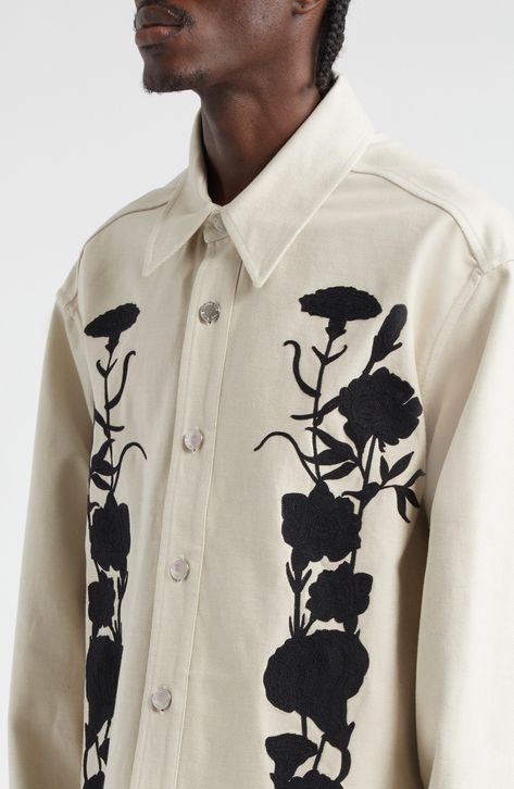 Shadowy floral embroidery blooming vertically brings the Australian label's eclectic spirit to an all-cotton shirt-jacket detailed with logo-engraved snaps. Front snap closure Point collar Snap cuffs Curved hem 100% cotton Dry clean Imported Designer Clothing Mens Embroidered Jacket, Haute Couture Menswear, Embroidered Menswear, Mens Embroidered Shirt, White Outerwear With Embroidered Graphics, Embroidered Cotton Button-up Outerwear, Jacket Painting, White Embroidered Shirt, Embroidery Shirt