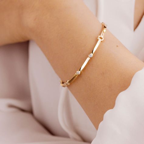 The Copley Multi Stone Bangle is delicate and fun, but boasts a big sparkle . The diamonds are delicately placed throughout the bangle, and this thinner design is a classic style to bring you from day to night. This bracelet can be worn alone or stacked with others for a bold effect. This bangle comes in either 18K Yellow Gold, or 18K White Gold. Rose gold available as a special order. It holds approximately .16 carats total weight of diamonds. Size medium. Hearts On Fire, Diamond Bracelet Design, Diamond Fashion Jewelry, Diamond Bangles Bracelet, Jewelry Appraisal, Stone Bangle, Bracelet Design, Sell Gold, Bangle Designs