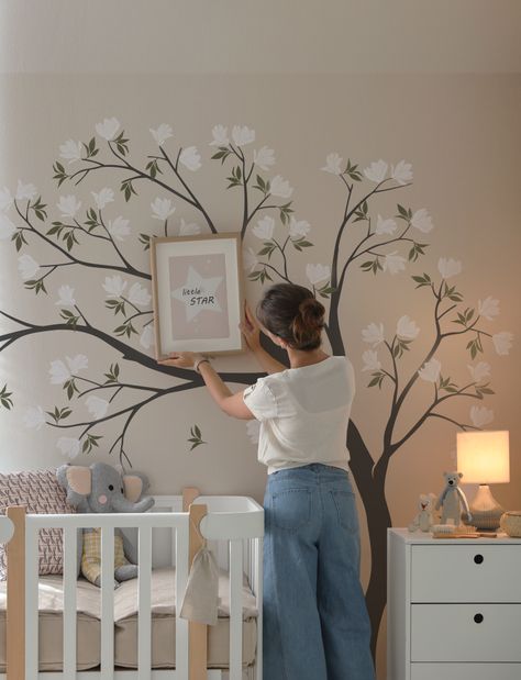 Suit up your kids' room with our unique Flowers Tree Wall Decal. This detailed, vibrant decal of magnolia flower drifting in the air will transform your empty, boring wall into a cozy nursery. Give your home a bold new look today! Floral Accent Wall Nursery, Gender Neutral Nursery Mural, Nursery With Mural, Tree Painting On The Wall, Nursery Tree Mural, Baby Room Wall Painting, Eloise Bedroom, Nursery Mural Ideas, Flower Nursery Theme