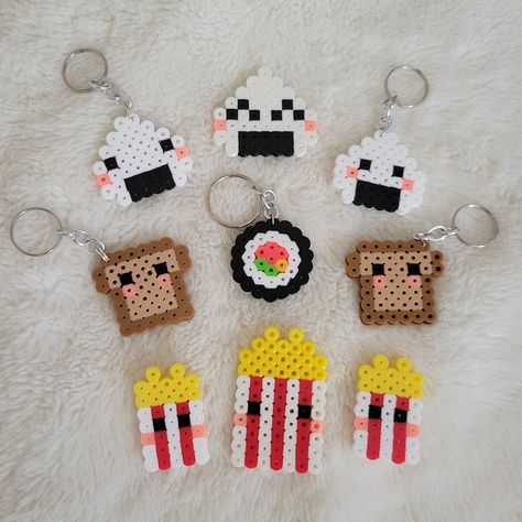 Always craving sushi or onigiri? Cause same. Show off your love for these foods with a cute little keychain! Dimensions:  W = 1.75in (4.5cm) L = 3in (7.5cm), including keychain **Disclaimer: Not all items will look exactly like the photo due to the item being individually made and ironed at different times** Peeler Bead Ideas Keychain, Cheer Perler Beads, Hama Bead Keyrings, Cute Perler Bead Keychains, Perler Beads Sushi, Fuse Bead Keychains, Popcorn Perler Beads, Pyssla Keychain, Perler Bead Patterns Keychains