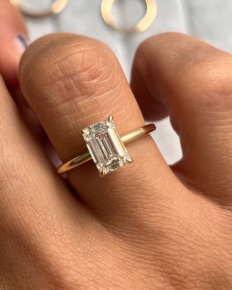 Our Aviva Solitaire Engagement Ring customized with an emerald cut diamond 💎 • • #finejewelry #engagement #enagementring #solitaireengagementring #emearldcut #gold #ring #rings💍 #engagementringinspo Emerald Gold Band Engagement Ring, Wedding Rings Gold Square, Gold Emerald Cut Diamond Ring, Emerald Cut Gold Band Engagement Ring, Thick Band Emerald Cut Engagement Ring, Engagement Rings Emerald Cut Gold, Gold Band Emerald Cut Engagement Ring, Small Emerald Cut Engagement Ring, Emerald Cut Gold Engagement Ring