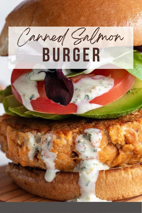 Salmon burger on a wooden board. Canned Salmon Burger Recipe, Teriyaki Salmon Burger, Salmon Patties Burgers, Salmon Burger Recipe Canned, Salmon Burger Meal Ideas, Salmon Hamburger, Salmon Burgers With Canned Salmon, Canned Salmon Burgers, Salmon Burger Toppings