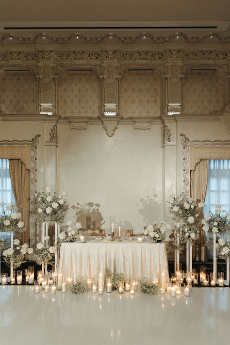 Simplistic romantic sweetheart table inspired by vintage European designs. White Wedding Esthetic, White Vintage Wedding Decor, Wedding With Candles And Lights, Vintage Glamour Wedding Decorations, Classic Vintage Wedding Theme, Elegant Classy Wedding Decor, Wedding Head Table Candles, Vintage Old Money Wedding, Ballroom Wedding Decoration