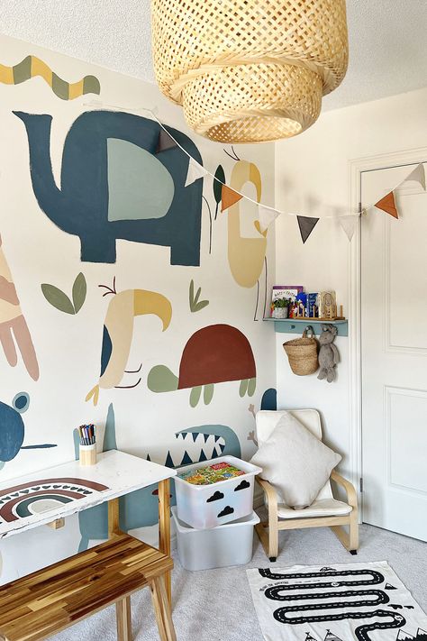 In this room, which belongs to DIYer Momina’s (@momina.zee) son, the walls were once blank and white, as is often the case for new builds. But Momina wanted to add a little more personality. “I wanted to make it more lively and exciting,” she says. Bedroom Wall Mural Painting, Nursery Mural Painted, Nursery Painted Wall Ideas, Baby Nursery Wall Ideas, Nursery Wall Design Paint, Daycare Paint Colors Wall, Diy Paint Mural, Kids Room Mural Ideas, Simple Nursery Mural