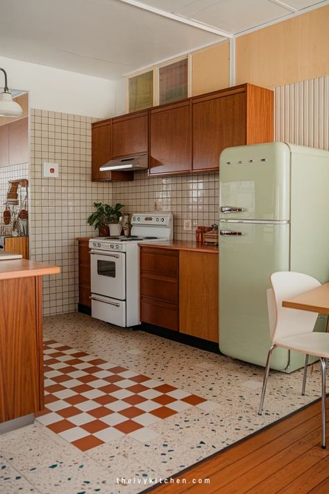 Vintage kitchen with wooden cabinets, retro mint green refrigerator, and patterned tile floor. Mid Century Modern Tiny Kitchen, Mid Century Modern Trailer, Midcentury House Interior, Mcm Small Apartment, 1960s Inspired Kitchen, Kitchen Interior Cozy, Mod Century Kitchen, Mid Century Modern Mobile Home, French Country Meets Mid Century Modern