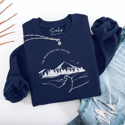 A cozy sweatshirt featuring a mountain and river backdrop with the quote 'the mountains are calling'. Perfect for outdoor enthusiasts and nature lovers, this sweatshirt gives off a serene and adventurous vibe. Ideal for chilly months, this classic fit sweatshirt with a crew neckline ensures a comfy wearing experience. Product Features: *Made with a medium-heavy fabric blend of 50% cotton and 50% polyester  *The classic fit along with the crew neckline deliver a comfy wearing experience with a clean-cut style. Meanwhile, the double-needle stitching at the shoulder, armhole, neck, waistband, and cuff seams add top-tier durability *Made using 100% ethically grown US cotton Care instructions: - Machine wash: cold (max 30C or 90F) - Non-chlorine: bleach as needed - Tumble dry: low heat - Do not Clean Cut, Nature Lovers, Top Tier, Heavy Fabric, Crew Neckline, Product Features, Care Instructions