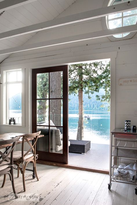 An oval transom window in a peaked planked vaulted ceiling in a dreamy white shiplapped lake cottage at Cultus Lake, BC Cottage Ceiling Lights, Planked Vaulted Ceiling, Modern Lake Cottage, Tiny Lake Cottage, Lakehouse Aesthetic, Small Lake Cottage Interiors, Lake Cottage Interiors, Lake Side Cottage, Small Lake Cabins