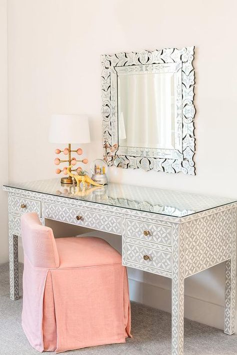 An elegant pink vanity chair sits at a black and white bone inlay desk topped with a gold and pink lamp and positioned beneath a Venetian vanity mirror. Bone Furniture, Pink Stool, Austin Interior Design, Girls Bedroom Colors, Chic Bedrooms, Pink Bedroom For Girls, Pink Vanity, Pink Lamp, Transitional Bedroom