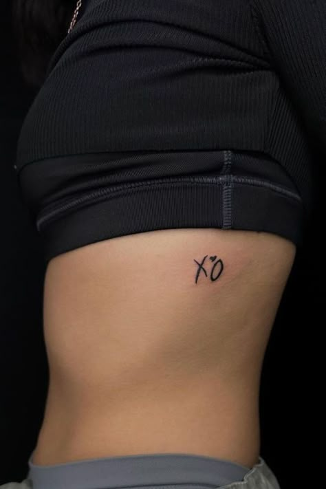 "Check out these tattoo ideas with 25 XO tattoos, bringing a gentle XO tattoo reminder of love and connection to your ink." The Weeknd Tattoo, Xo Tattoo, Smiley Face Tattoo, Record Label Logo, Small Girly Tattoos, Ribcage Tattoo, Chic Tattoo, Beautiful Tattoos For Women, Cute Tattoos For Women