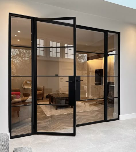 Affordable Elegance with Black Aluminium Crittall Style Doors: Elevate your home's interior and exterior with the timeless appeal of Crittall style doors. This blog post offers practical tips on how to incorporate these sleek, black aluminium doors into your space, ensuring luxury and style on a budget. Ideal for homeowners looking for a high-end look with affordability. Crittall Style Doors, Black Crital Doors, Large Crittal Doors, Black Metal Office Door, Black And Glass Doors Interior, Black Glass Metal Door, Glass Interior Walls In House, Black Paned Glass Wall, Timber Crittal Style Doors