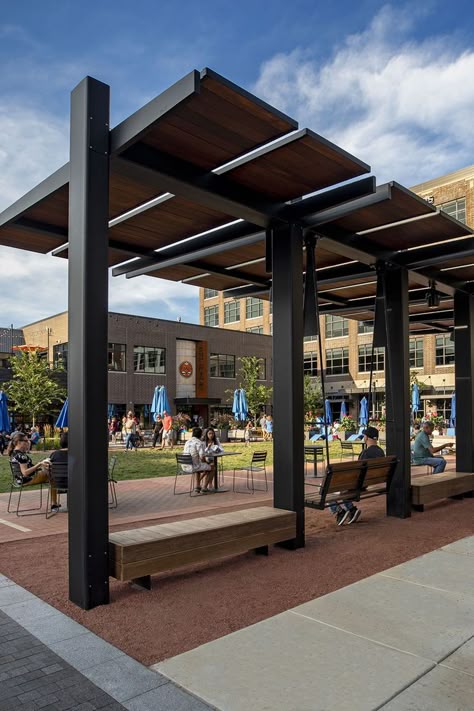 Midtown Plaza along the new Monon Boulevard comes alive on warm summer evenings in Carmel, IN. Studio 431’s custom bench swings and shade structures are hubs of activity as people relax, connect and play in the multi-use urban linear park. #LandscapeForms #customspaces #architectureinspiration Pergola Shade Ideas, Park Shade Structure, Modern Pergola Designs, Custom Bench, Linear Park, Covered Walkway, Custom Canopy, New Urbanism, Shade Design