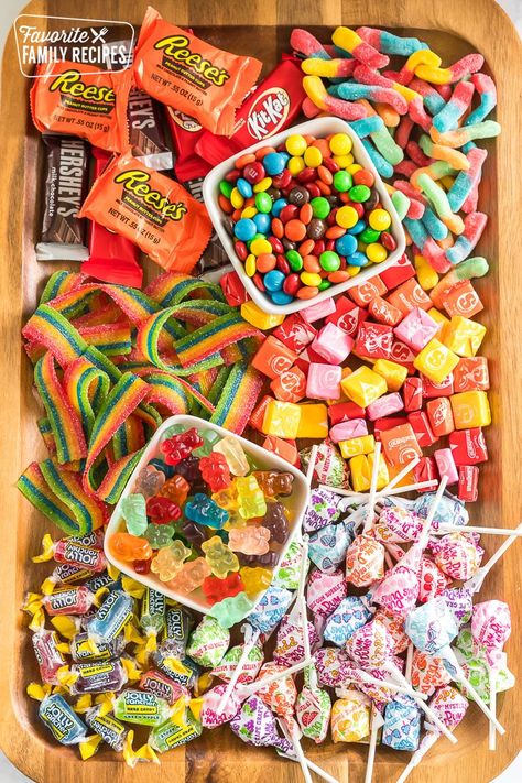 This is the ultimate candy charcuterie board and perfect for movie night or game night! Plus it can be customized to your taste. #candycharcuterieboard #charcuterieboard #movienight #gamenight #snackideas Candy Food Board, Movie Night Grazing Board, Small Candy Charcuterie Board, Candy Snack Board, Charcuterie Candy Board Ideas, Movie Night Food Board, Gummy Candy Charcuterie Board, Games Night Snacks, Candy Boards For Parties