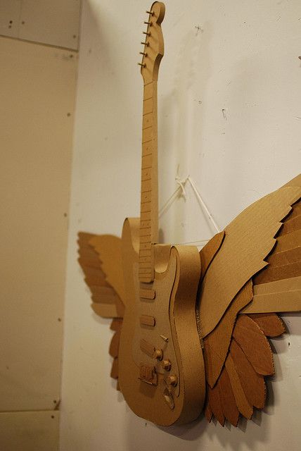 Cardboard winged-guitar by atduskgreg, via Flickr Cardboard Guitar Diy, Paper Guitar, Cardboard Paper Mache, Cardboard Guitar, Cardboard Art Sculpture, Cardboard Props, Diy Cardboard Toys, Cardboard Crafts Diy, Guitar Diy