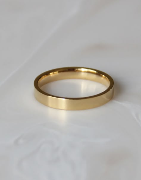 This beautiful gold band ring is a perfect statement piece to be worn alone or layered with other rings. *All sale items are final sale* 2.5mm comfort fit band Base Material: High Quality Surgical Steel Finish: 18k Gold over surgical steel Nickel Free and Lead Free Waterproof and tarnish resistant Simple Gold Ring Band, Wedding Bands For Women Gold Simple, Gold Band Ring Women, Plain Gold Band Wedding Ring, Flat Band Ring, Womens Simple Wedding Band, Simple Gold Bands, Simple Band Rings, Plain Gold Wedding Band Woman