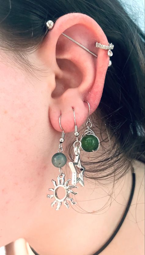 Hippie Ear Piercings, Green Piercing Aesthetic, Fairy Grunge Piercings, Goth Earring Stack, Maxamilist Ear Piercings, Ear Piercing Sets Grunge, Ear Stacking Ideas Grunge, Green Academia, Multiple Ear Piercings