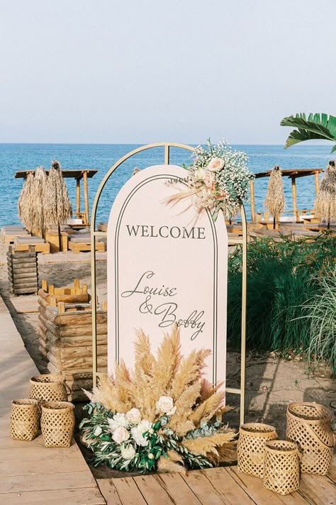 “Whimsical Folk” Wedding Style. Coastal ceremony at Tulum. Reception at Kalami Beach Bar Restaurant. Mediterranean Sea Views. Colors: White, Beige, Terracotta, Dusty Pink, Green. Destination Wedding Planned by Golden Apple Weddings, Rhodes Island. Bride and Groom Wedding Portraits. #destinationweddings #Greece #Rhodes #island #bohowedding #beachwedding #beachbar #weddingtheme #weddingdecor #weddingevent #weddingphotography #weddingplanning #welcomesign #rattanlanterns #flowersynthesis #pampas Mediterranean Beach Wedding, Wedding Welcome Sign Beach, Beach Wedding Welcome Sign, Beach Reception Decor, Pampas And Roses, Coastal Ceremony, Beach Reception Decorations, Coastal Wedding Reception, Beachy Boho Wedding