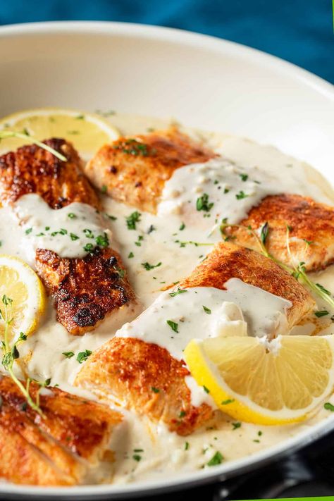 Mahi Mahi with Garlic Cream Sauce is a quick, elegant dish. Spice-rubbed Mahi fillets are pan-seared to a crisp exterior nestled in a creamy garlic and herb sauce. One pot recipe that pairs perfectly with pasta, potatoes, or green veggies! Fish In A Cream Sauce, Mahi Mahi With Cream Sauce, Dinner Ideas With Mahi Mahi, Cajun Mahi Mahi Recipes, Fish With Pasta Recipes, Mahi Mahi With Lemon Garlic Cream Sauce, Crispy Mahi Mahi Recipes, Garlic Cream Sauce For Fish, Mahi Mahi Cream Sauce