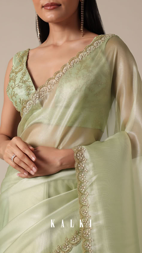 "Step into sophistication with this Graceful Green Tissue Saree. It is featuring meticulous bead and cutdana work on a scalloped border. The light green and glass tissue accents enhance the overall appeal, creating a perfect choice for your party wear collection. Meticulous detailing and the inclusion of unstitched blouse fabric ensure a customized fit.
" Light Green Organza Saree, Blouse Designs For Green Saree, Plane Saree Blouse Styles, Scallop Border Saree, Pista Green Tissue Silk Saree, Saree Designs Party Wear Wedding, Sage Green Saree, Pelli Choopulu, Light Green Saree