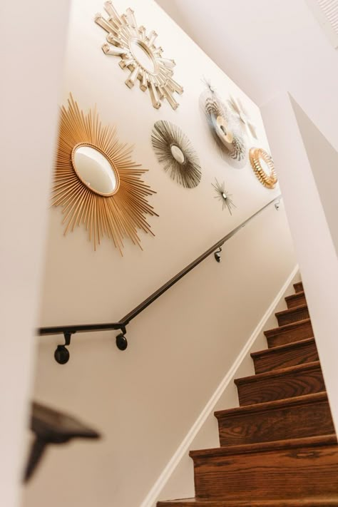 Like the collection of the starbursts. Stairs Wall Decor Ideas Mirror, Decoration For Stairs Wall, Interior Stairs Wall Design, Stairway Wall Decorating Ideas Modern, Boho Staircase Wall, Staircase Wall Decor Mirrors, Steps Wall Decor Stairs, Stairs Ideas Decoration Stairways, Feature Wall On Stairs