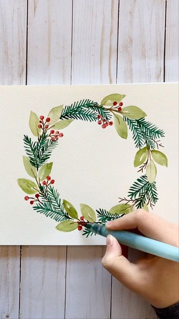 Heidi on Instagram: "Tis the season for painting more Christmas wreaths! I like painting small, but this time I wanted to do a bigger one and make it more full. I find wreaths to be such a fun thing to paint. I have a full tutorial for how to paint this wreath on my YouTube channel - link is in my profile! Supplies used: watercolor paper, watercolor paint, Sakura Koi water brush, Uniball Signo white gel pen to add highlights at the end . . . #watercolorwreath #watercolorchristmas #christmasactivities #christmaspainting" Primitive Christmas Patterns, Thing To Paint, Water Brush, Christmas Card Art, Diy Watercolor Painting, Watercolor Christmas Cards, White Gel Pen, Wreath Watercolor, Diy Watercolor