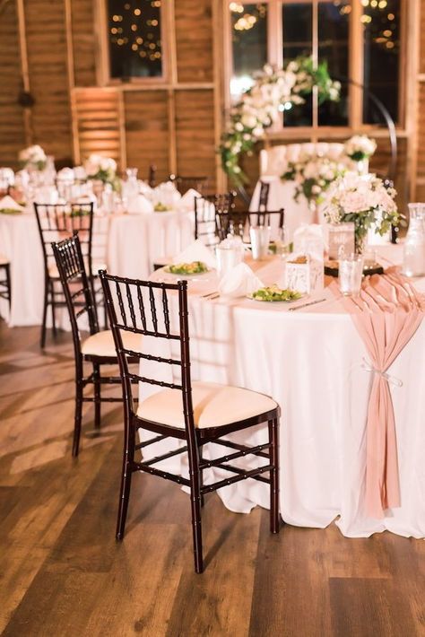 Guests sat at round tables with white tablecloths and pink runners in the authentic renovated dairy barn at this pink fall wedding at 48 Fields in Northern Virginia. #barnwedding #fallwedding #pinkwedding #receptiondecor #weddingreception #floralring #moongate #virginiawedding #weddingvenue Table Cloth Colors For Weddings, Round Table Table Runner Wedding, Runner Round Table Wedding, Runner On Circle Table, Round Wedding Table With Runner, Table Coverings For Wedding, Table Runners For Round Tables Wedding, Table Runners Circle Tables, Wedding Round Table Runner