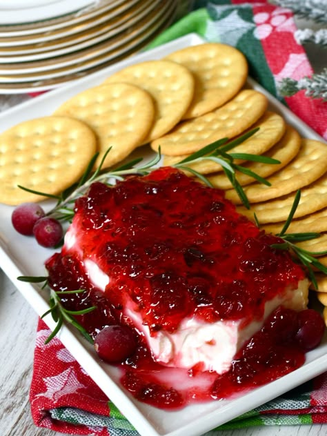 Cranberry jalapeno pepper jelly over cream cheese garnished with rosemary served with crackers. Pepper Jelly For Canning, Canned Pepper Jelly Recipe, Cranberry Jelly Recipes Thanksgiving, Flavored Pepper Jelly Recipe, Cranberry Orange Pepper Jelly, Pomegranate Pepper Jelly, Hot Pepper Cranberry Jelly, Cream Cheese And Spicy Jelly, Recipes With Candied Jalapenos